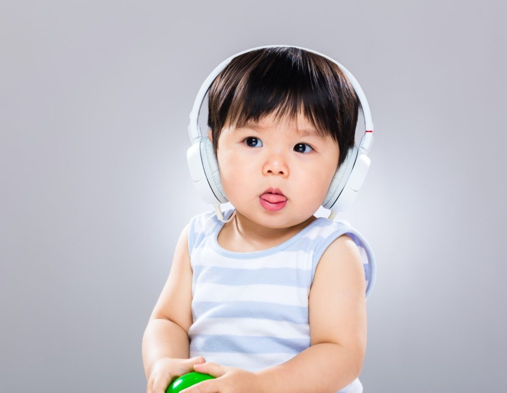 Baby boy listen to music with headphone